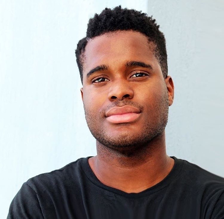 Young man with dark skin wearing a black shirt